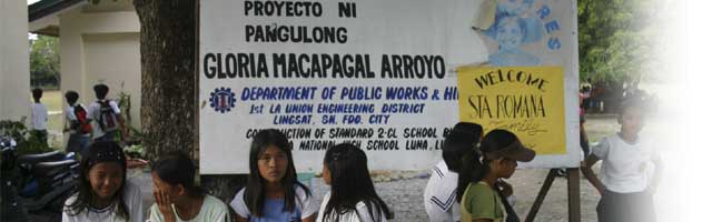 Students at the Luna National Hign School in Luna, La Union enjoy "talking story" behind a sign that reads two classrooms were erected as a project of GMA